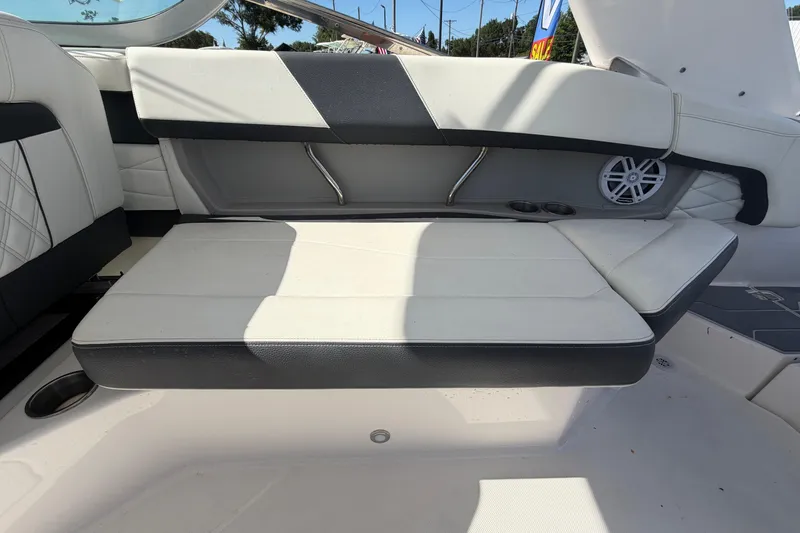 Slide: The Image of 2021 Regal 26 FasDeck boat interior with white seating and speaker system. - 67