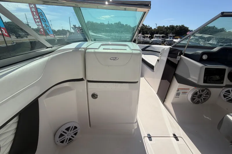 Slide: The Image of 2021 Regal 26 FasDeck boat interior with seating and speakers, showcasing modern design. - 41