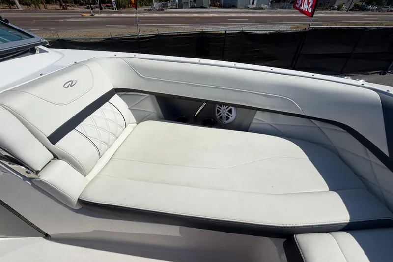 Slide: The Image of 2021 Regal 26 FasDeck boat interior with white cushioned seating and speaker. - 53