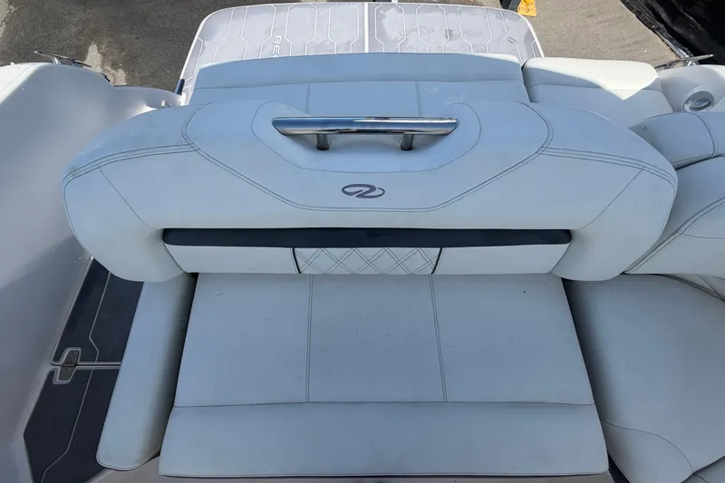 Slide: The Image of 2021 Regal 26 FasDeck boat interior seating with white upholstery and sleek design. - 79