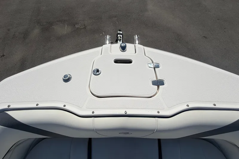 Slide: The Image of Bow view of 2021 Regal 26 FasDeck boat, featuring sleek white deck design. - 48