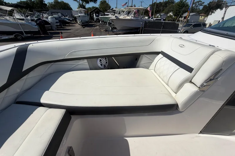 Slide: The Image of 2021 Regal 26 FasDeck boat interior with white cushioned seating. - 55