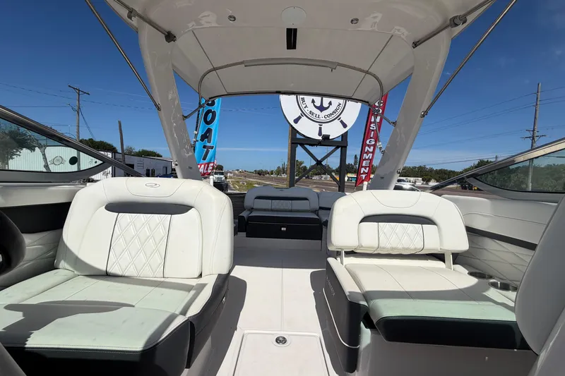 Slide: The Image of 2021 Regal 26 FasDeck boat interior with white seating and open deck view. - 61