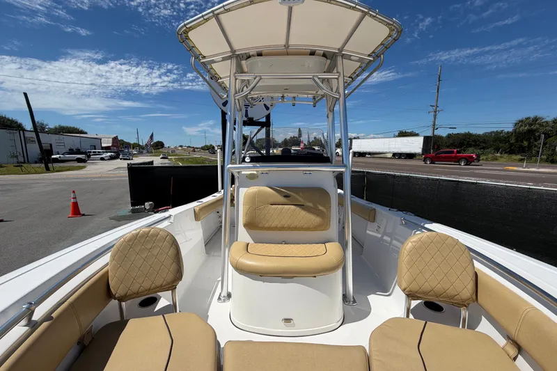 Slide: The Image of 2021 Sportsman Heritage 211 Center Console boat with tan seating and T-top canopy. - 56