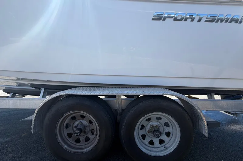 Slide: The Image of 2021 Sportsman Heritage 211 Center Console boat on trailer, side view. - 80