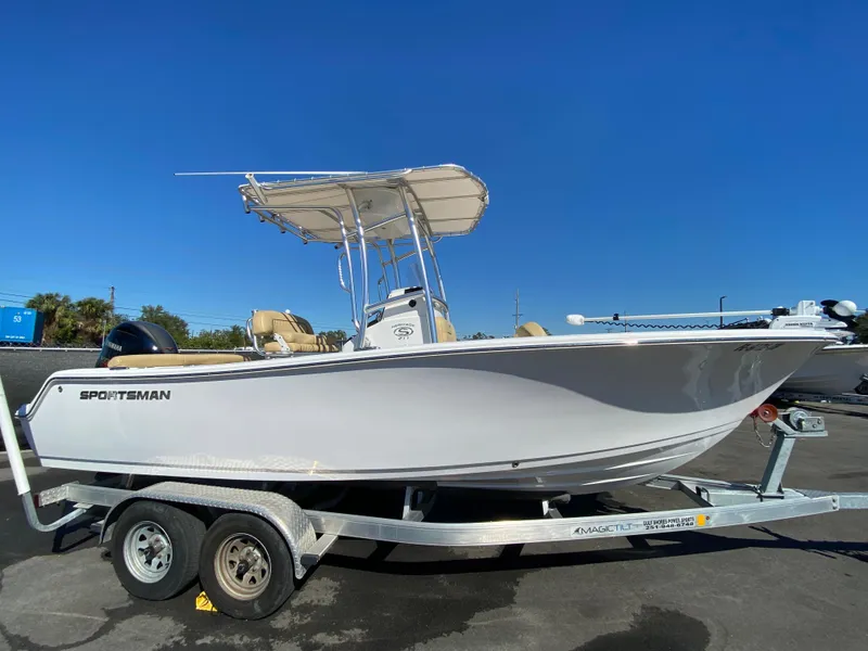 Slide: The Image of 2021 Sportsman Heritage 211 Center Console boat on trailer, clear blue sky background. - 1
