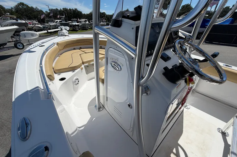 Slide: The Image of 2021 Sportsman Heritage 211 Center Console boat interior with steering wheel and seating area. - 32