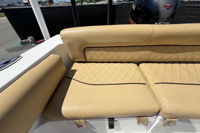 Slide: The Image of 2021 Sportsman Heritage 211 Center Console boat with tan cushioned seating. - 64