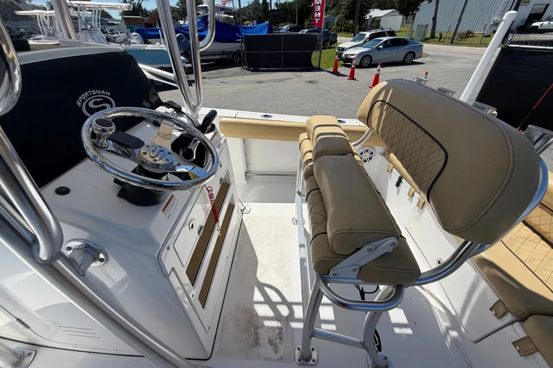 Slide: The Image of 2021 Sportsman Heritage 211 Center Console boat interior with steering wheel and cushioned seating. - 17
