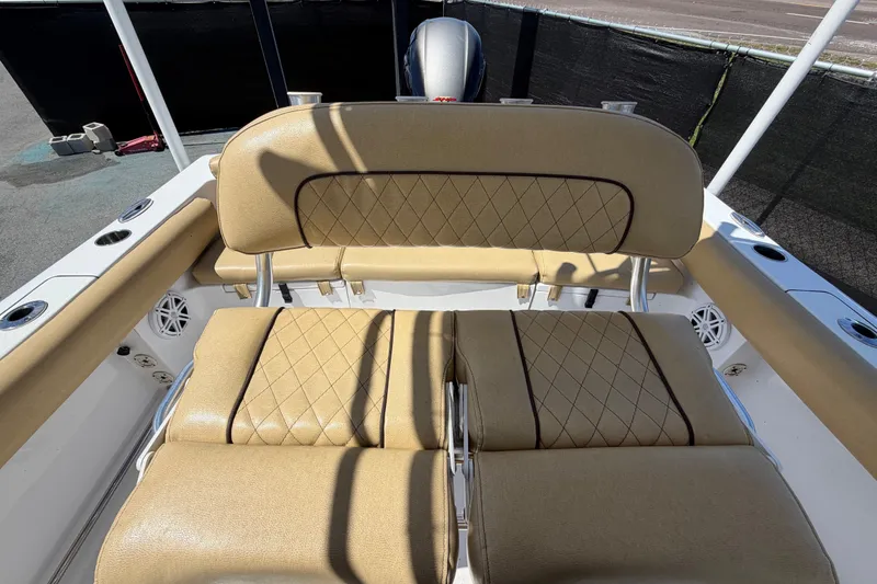 Slide: The Image of 2021 Sportsman Heritage 211 Center Console boat with tan cushioned seating. - 62