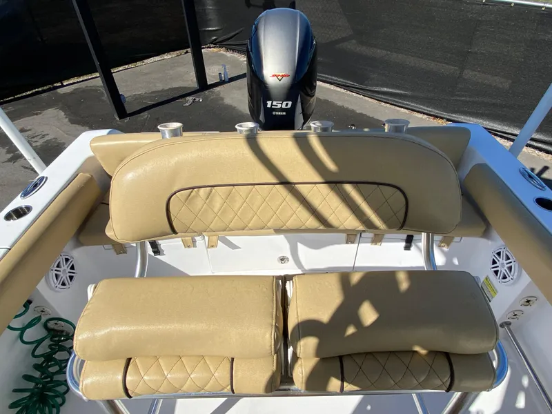 Slide: The Image of 2021 Sportsman Heritage 211 Center Console boat with tan seating and Yamaha 150 engine. - 36