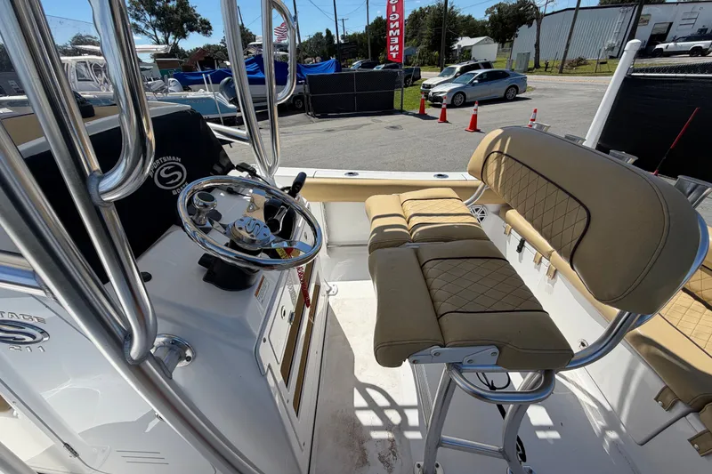 Slide: The Image of 2021 Sportsman Heritage 211 Center Console boat interior with steering wheel and seating. - 16