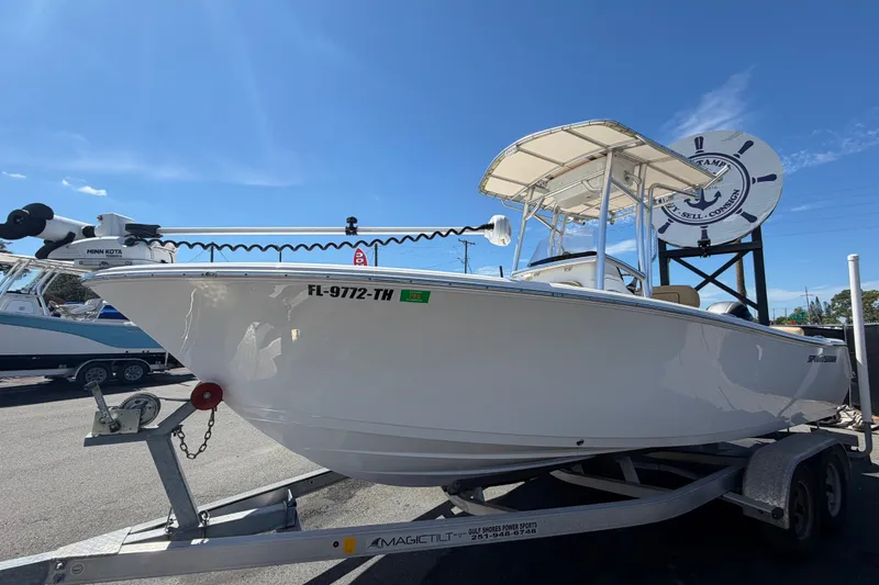 Slide: The Image of 2021 Sportsman Heritage 211 Center Console boat on trailer under clear blue sky. - 9