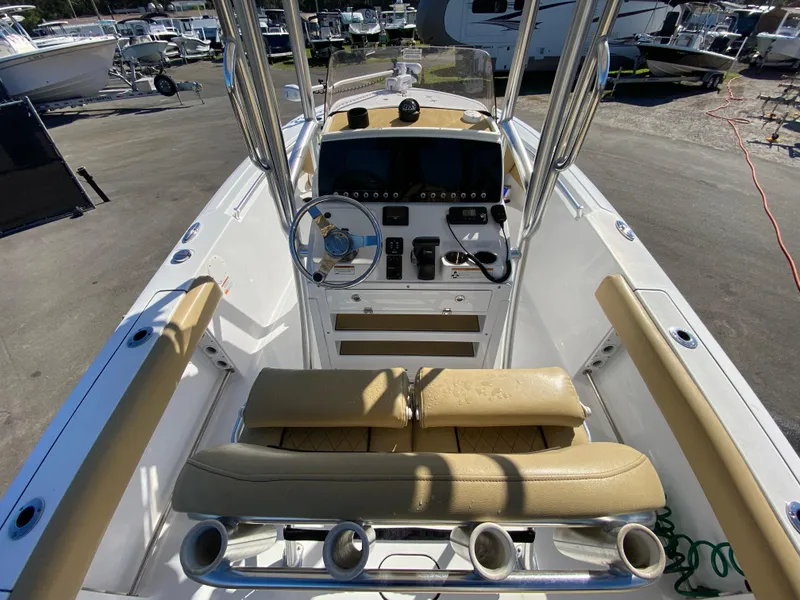 Slide: The Image of 2021 Sportsman Heritage 211 Center Console boat interior with tan seating and control panel. - 11