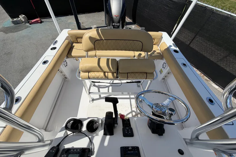 Slide: The Image of 2021 Sportsman Heritage 211 Center Console boat interior with steering wheel and seating. - 60