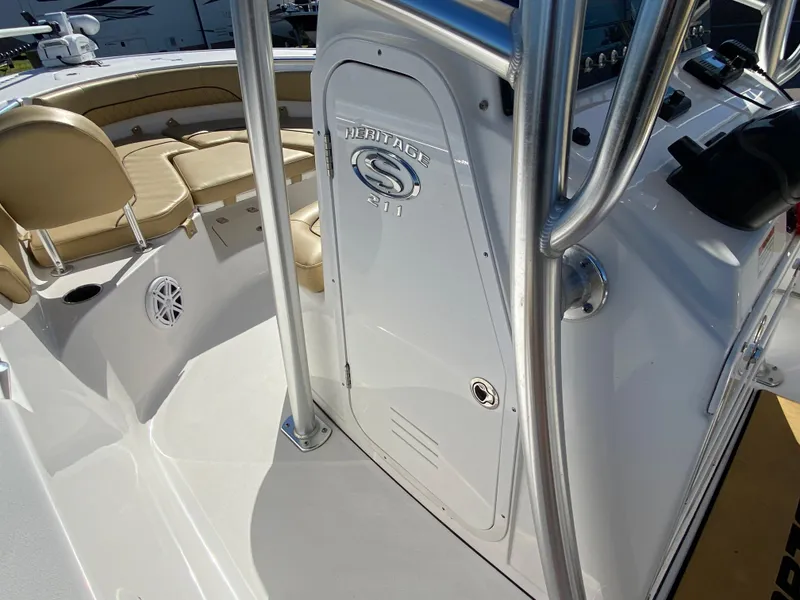 Slide: The Image of 2021 Sportsman Heritage 211 Center Console boat interior with beige seating and console details. - 15