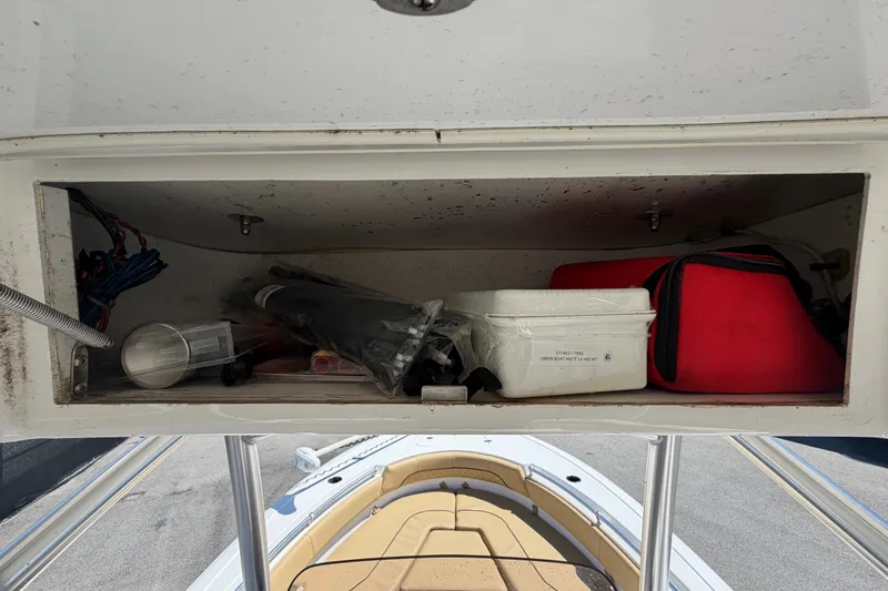 Slide: The Image of Storage compartment on a 2021 Sportsman Heritage 211 Center Console boat with various items. - 19