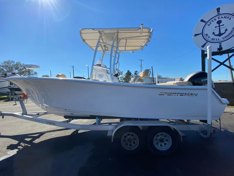 Slide: The Image of 2021 Sportsman Heritage 211 Center Console boat on trailer under sunny sky. - 7