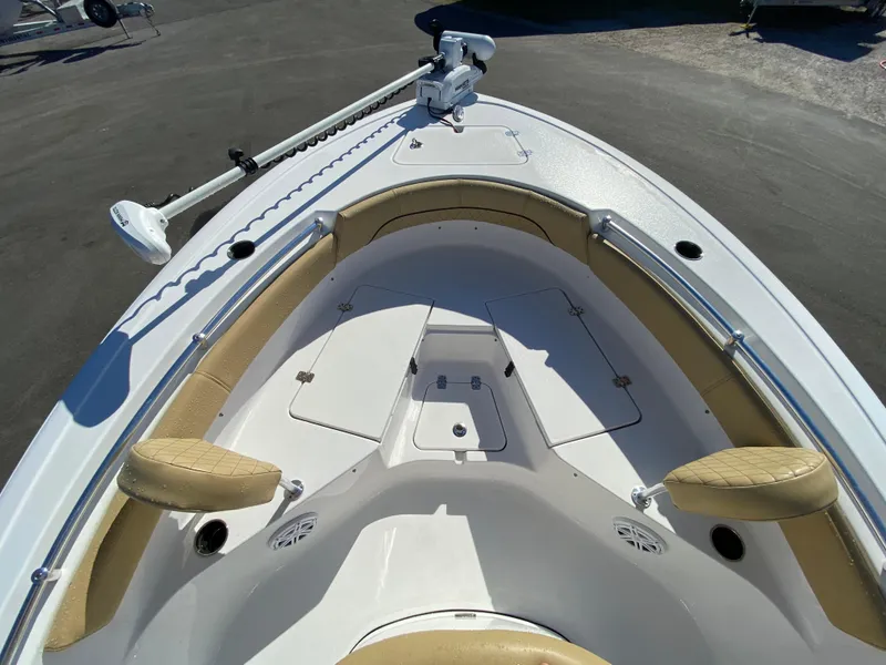 Slide: The Image of 2021 Sportsman Heritage 211 Center Console boat with tan seating and trolling motor. - 23