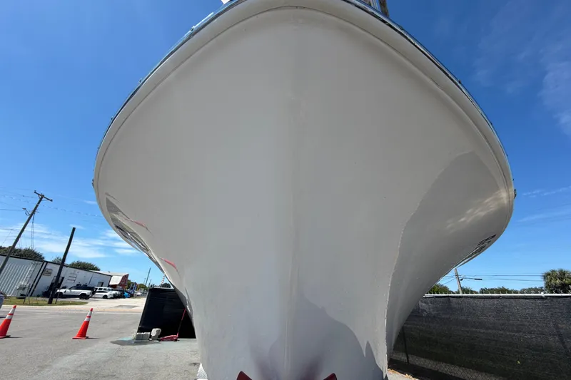 Slide: The Image of 2021 Sportsman Heritage 211 Center Console boat, viewed from the front, under clear blue sky. - 10