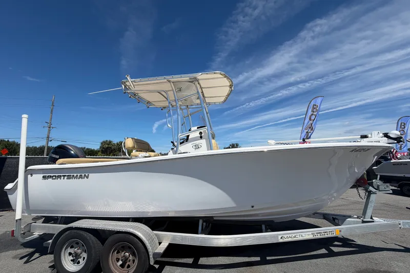 Slide: The Image of 2021 Sportsman Heritage 211 Center Console boat on trailer under clear blue sky. - 1