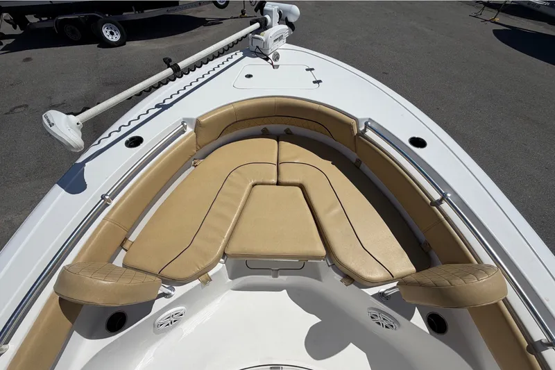 Slide: The Image of The image shows the bow of a Sportsman Heritage 211 Center Console boat with beige cushions. - 38