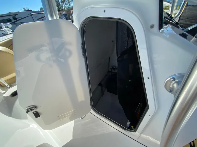 Slide: The Image of 2021 Sportsman Heritage 211 Center Console storage compartment open on deck. - 16