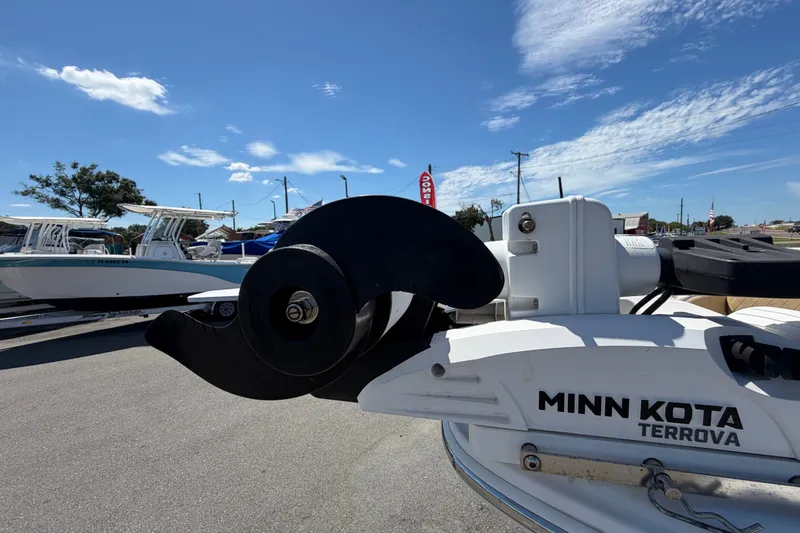Slide: The Image of 2021 Sportsman Heritage 211 Center Console with Minn Kota Terrova motor, docked under blue sky. - 53