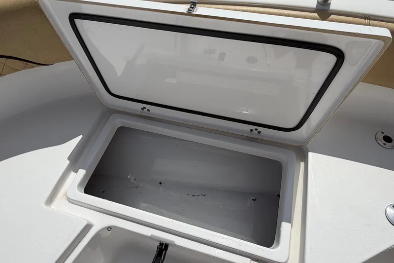 Slide: The Image of An open storage compartment on a 2021 Sportsman Heritage 211 Center Console boat. - 48