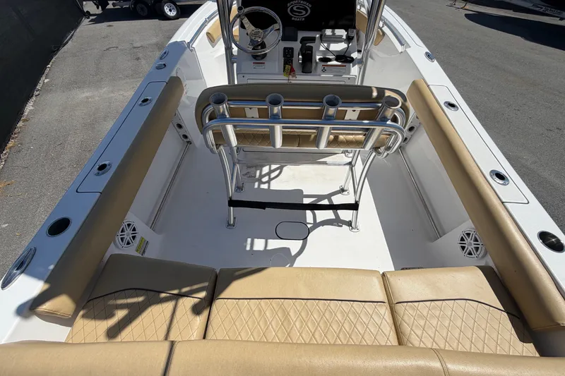 Slide: The Image of 2021 Sportsman Heritage 211 Center Console boat interior with tan seating and rod holders. - 14