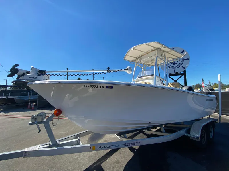 Slide: The Image of 2021 Sportsman Heritage 211 Center Console boat on trailer under clear blue sky. - 8