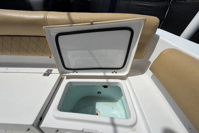 Slide: The Image of Open storage compartment on 2021 Sportsman Heritage 211 Center Console boat. - 73