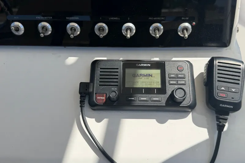 Slide: The Image of Garmin marine radio and controls on 2021 Sportsman Heritage 211 Center Console boat. - 26