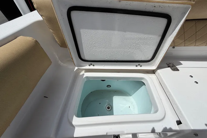Slide: The Image of Open storage compartment on 2021 Sportsman Heritage 211 Center Console boat. - 66