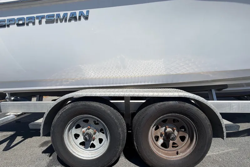 Slide: The Image of 2021 Sportsman Heritage 211 Center Console boat on trailer, showcasing dual wheels. - 79