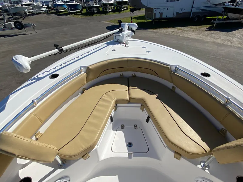 Slide: The Image of 2021 Sportsman Heritage 211 Center Console boat with tan seating and trolling motor. - 19