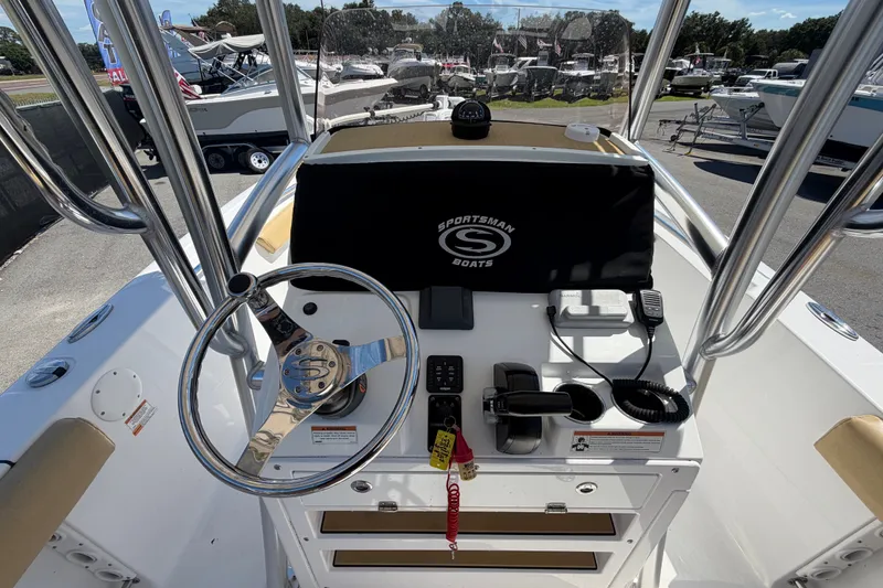 Slide: The Image of 2021 Sportsman Heritage 211 Center Console boat dashboard with steering wheel and controls. - 20