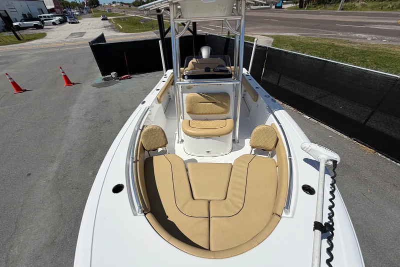 Slide: The Image of 2021 Sportsman Heritage 211 Center Console boat with tan seating, docked on pavement. - 54