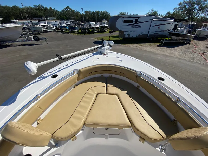 Slide: The Image of 2021 Sportsman Heritage 211 Center Console boat with tan seating, parked in a marina. - 20