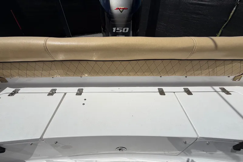 Slide: The Image of 2021 Sportsman Heritage 211 Center Console boat interior with cushioned seating and storage compartments. - 68