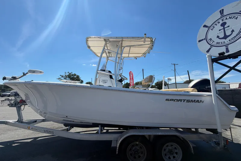 Slide: The Image of 2021 Sportsman Heritage 211 Center Console boat on trailer under clear blue sky. - 8