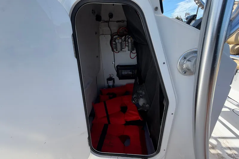 Slide: The Image of Storage compartment of 2021 Sportsman Heritage 211 Center Console with life jackets and equipment. - 34