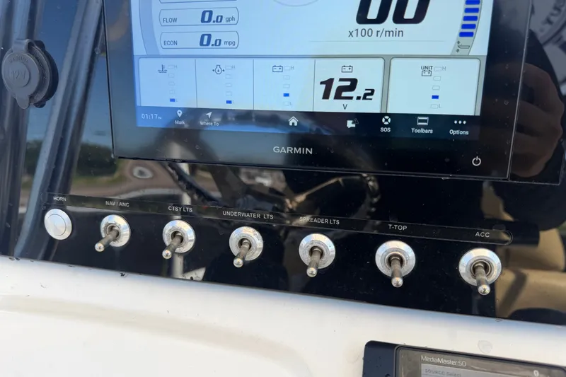 Slide: The Image of Control panel of a 2021 Sportsman Heritage 211 Center Console boat with Garmin display. - 27
