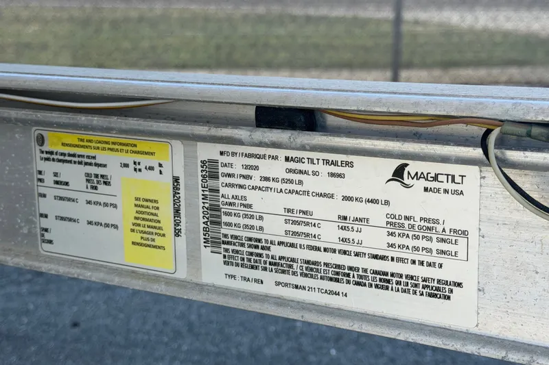 Slide: The Image of Label on Magic Tilt trailer for 2021 Sportsman Heritage 211 Center Console. - 78
