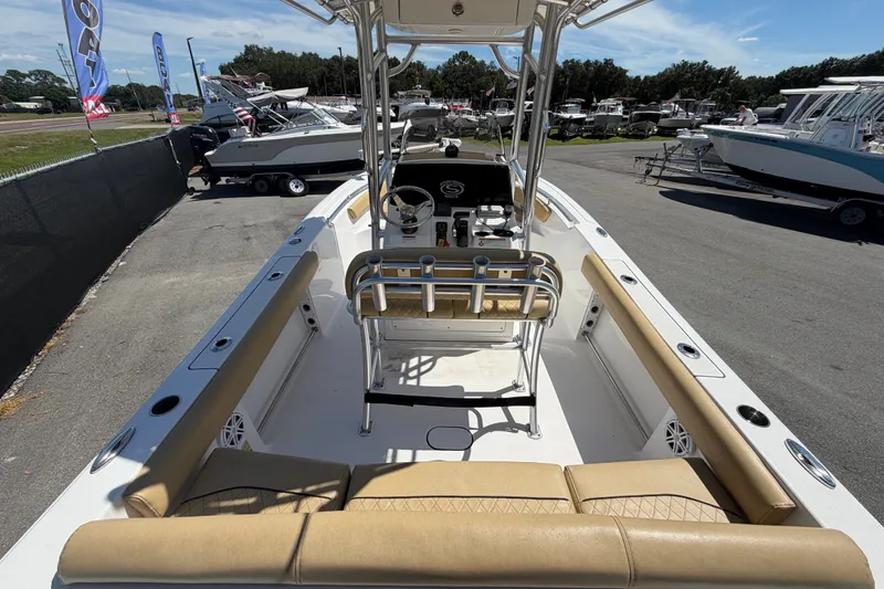 Slide: The Image of 2021 Sportsman Heritage 211 Center Console boat with tan seating, parked outdoors. - 12