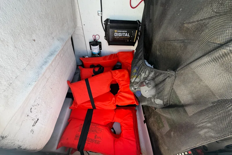 Slide: The Image of Life jackets and equipment storage on a 2021 Sportsman Heritage 211 Center Console boat. - 36