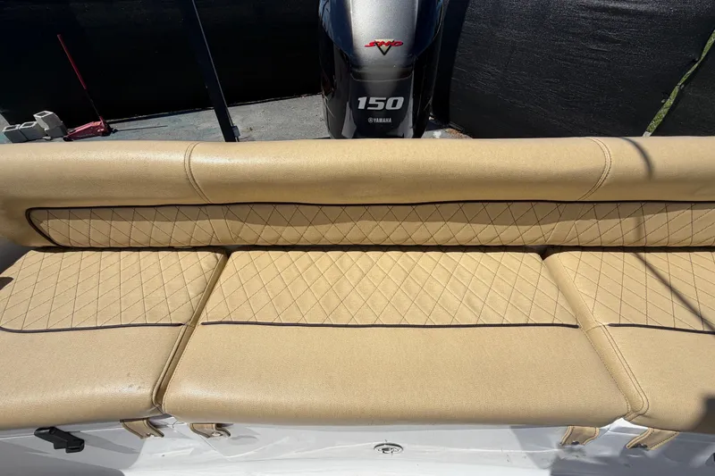 Slide: The Image of 2021 Sportsman Heritage 211 Center Console boat with tan quilted seating and Yamaha 150 engine. - 67