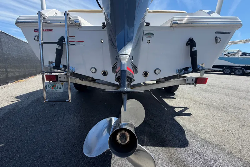 Slide: The Image of 2021 Sportsman Heritage 211 Center Console boat rear view with propeller and ladder. - 4