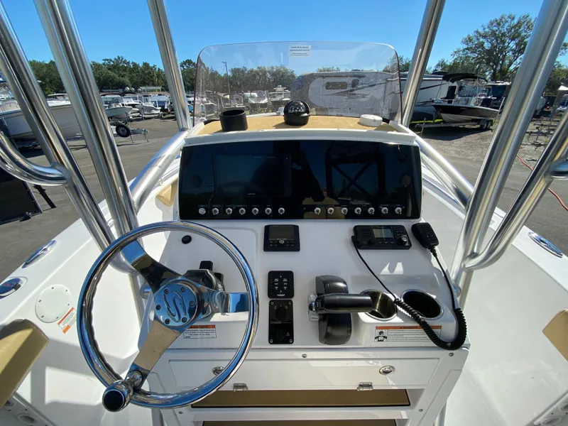 Slide: The Image of 2021 Sportsman Heritage 211 Center Console boat dashboard with steering wheel and controls. - 13