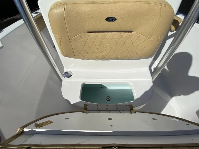 Slide: The Image of 2021 Sportsman Heritage 211 Center Console boat interior with tan seating and storage compartment. - 35
